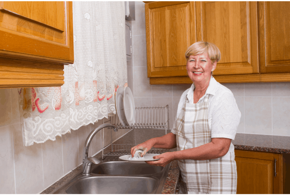 woman washing dishes independence in your home- older adults - Buffalo Occupational Therapy - Experts in Rehab - Neurological Rehabilitation